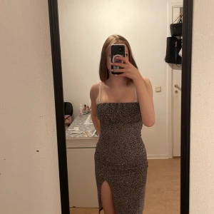 Klänning - Svart midi klänning med rosa/vita mönster, köpt på new yorker, säljer då den aldrig kommer till användning 