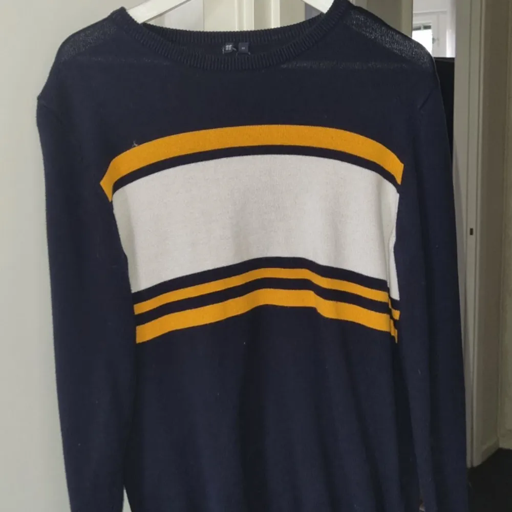 En stickad tröja i blått, gult och vitt . Tröjor & Koftor.