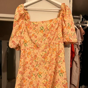 Klänning från Nelly  - Använd 2 gånger.  Kort klänning med Lätt puffärm. Resår och dragkedja i ryggen för optimal komfort och passform.