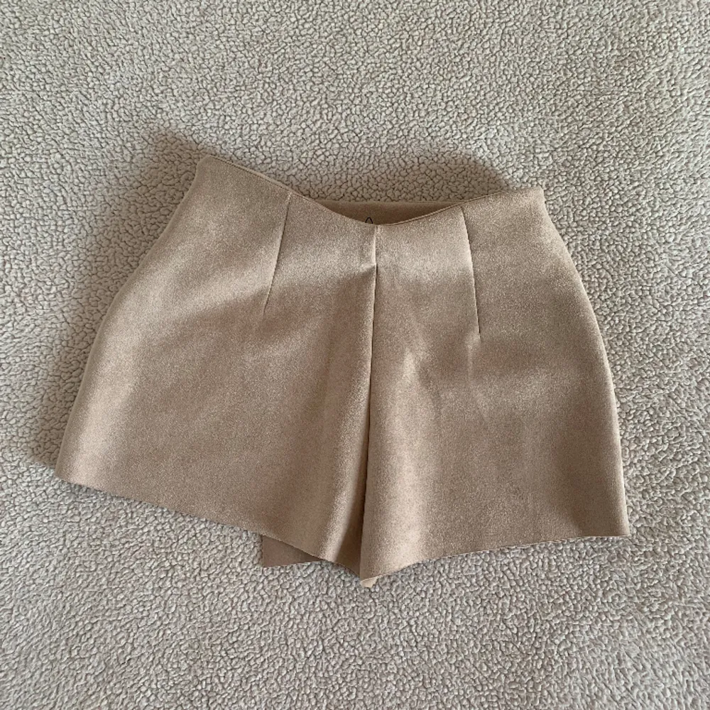Otroligt vacker kjol (skorts) i mocka imitation från ZARA med inbyggda shorts. Ny med tags kvar, utan anmärkningar.. Kjolar.
