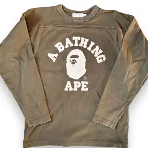 A BATHING APE Japanese-made printed long-sleeve  Size: S Released in the early 2000s, very rare item  Good Condition for its age, has some cracking and discoloring on the print  Measurements Top: Width: 49cm Length: 64