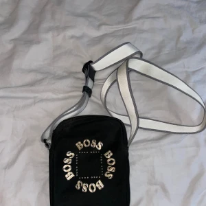 Hugo boss axelväska - En Hugo boss axelväska som har knappt används, den har inga märken och är i bra skick.