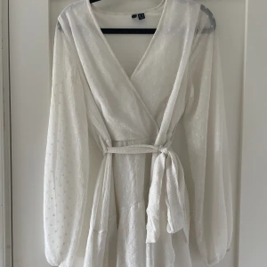 Klänning  - Vit omlott klänning från vero Moda använd 1 gång. Som ny. Skriv för fler bilder eller frågor! Superfin till avslutning, student eller konfirmation🤍