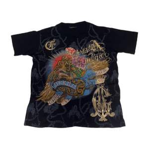 Vintage Christian Audigier T-shirt med rhinestones. Aldrig använd. Har legat på vind i 15 år. [Längd 63cm] [Bredd 52cm]
