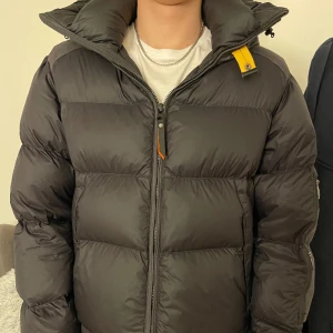 Parajumper vinterjacka herr - Mörkgrå dunjacka från parajumpers i storlek L. Två fickor fram med dold dragkedja, två fickor på vänster arm och två innerfickor. Köpt i oktober 2023 för 9 599kr, ny/mycket bra skick (inga dekefter) skriv för fler bilder och frågor.