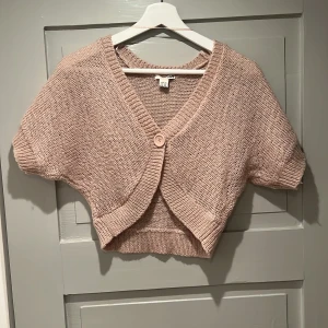 Ljusrosa glittrig bolero  - Kortärmad bolero från hm som passar utmärkt som lite extra värme över bysten, till fest eller vid amning. 