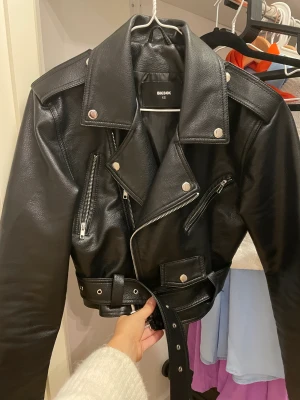 Skinnjacka - En supersnygg skinnjacka från BikBok i XS som sitter som en smäck man får verkligen snatched midja med den. Tyvärr är den för kort på mina armar och tajt i ryggen. Den är i perfekt skick då jag endast använt en gång.