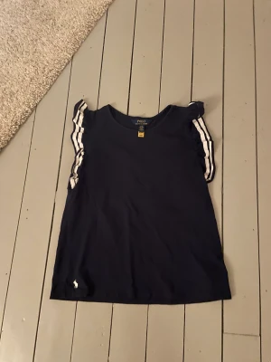 T-shirt - Säljer denna T-sjukt med volanger då den inte kommer till användning. Den är använd typ 10 gånger så i bra skick.  Frakt 29kr