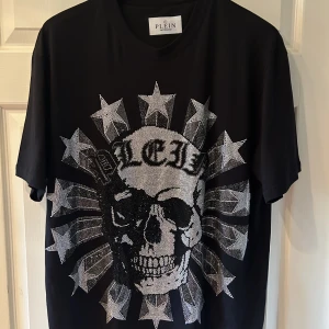 Philipp Plein - Exklusiv Philipp Plein T-shirt – Perfekt skick!  Denna otroliga Philipp Plein t-shirt är det ultimata tillskottet till din garderob! Med sin unika design och högkvalitativa utförande kommer den definitivt att dra till sig uppmärksamhet  Nypris 10000kr