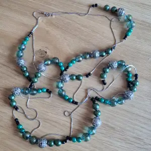 Långt halsband som kan bäras i 1, 2 eller 3 varv  Gröna, svarta och silvriga pärlor 