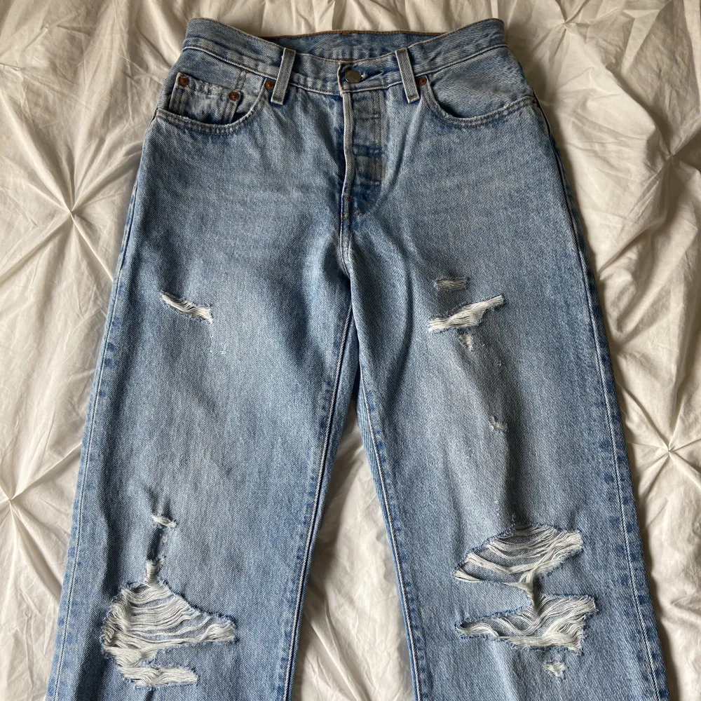 Jätte snygga jeans med slitningar från Levi’s, modell 501. Storlek 24/32. Passar nog även 25/32 beroende på hur du vill att de sitter. Helt nya och aldrig använda utöver testade!!. Jeans & Byxor.