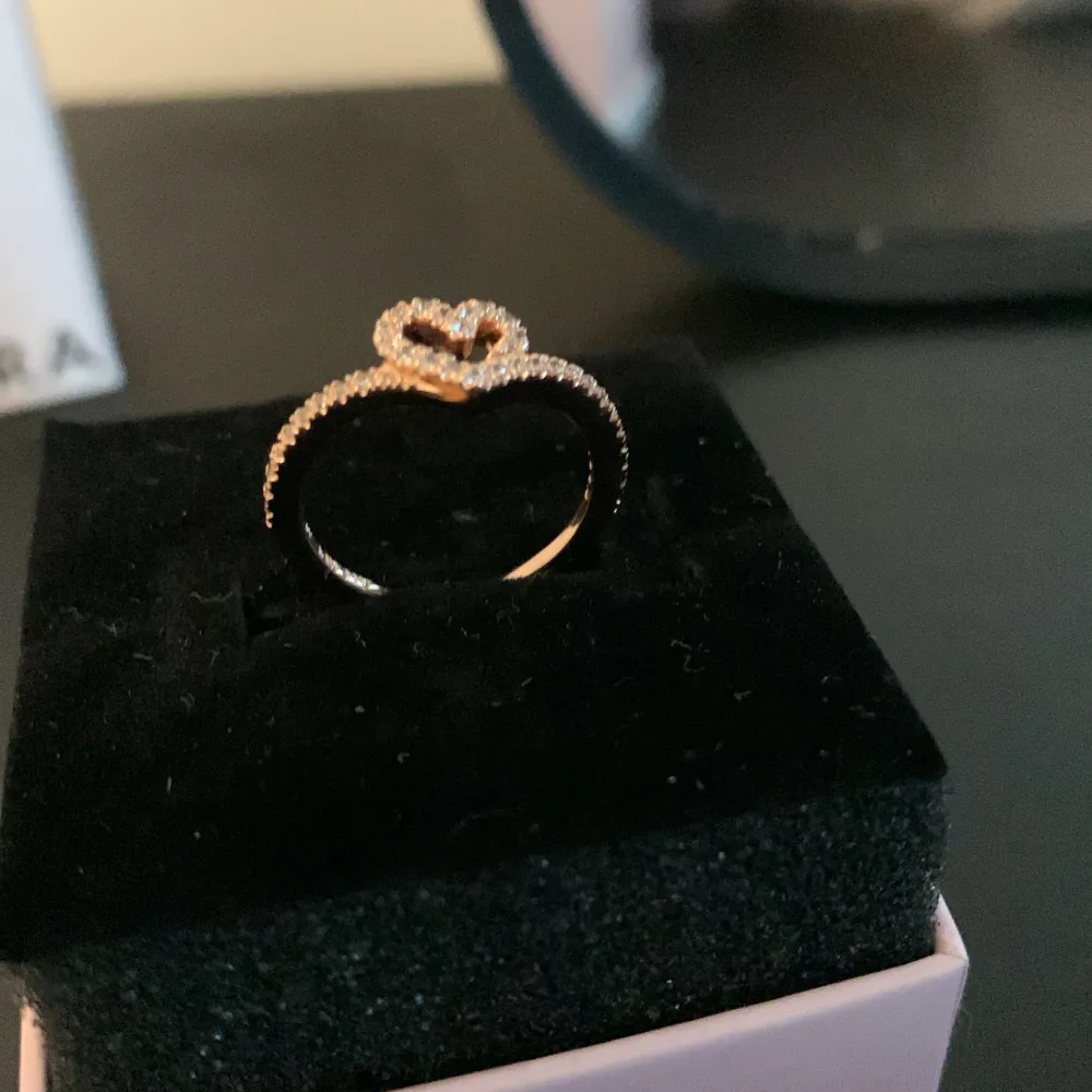 Säljer en Pandora-ring och den är, den senaste, aldrig använd. Säljer den för att jag tänkte att den kanske är för yngre tjejer eftersom den har ett hjärta i sig. Om du är från Sverige Stockholm, hör av dig så kan vi prata i detalj. Storlek 48 i ringstorl. Accessoarer.