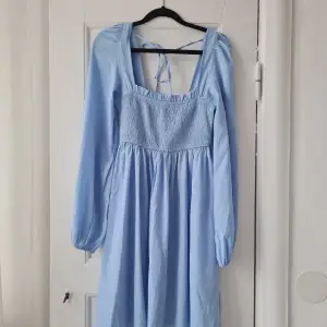 Superfin babyblå klänning med puffiga ärmar och square skärning. Från NA-KD