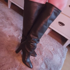 Knähöga stövlar i äkta italienskt skinn, st 39 (38) - Knähöga stövlar i äkta och mjukt italienskt skinn, st 39. Helt nya och oanvända, klassisk modell stövlar som inte blir omoderna i första taget!