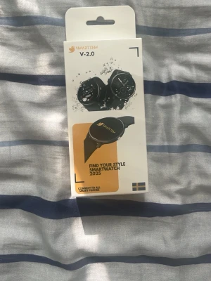 Smarttiem V-2.0 Smartwatch svart - Smarttiem V-2.0 Smartwatch i svart med rund urtavla och silikonarmband. Klockan är vattentät och kan kopplas till alla smartphones. Modern design med tydlig display och flera smarta funktioner som stegräknare och notiser.
