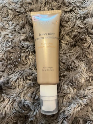 Hickap Honey Glow Priming Moisturizer - Honey glow priming moisturizer som aldrig är använd, från Hickap i en lyxig guldig tub med pump. Primern är vegansk och passar alla hudtyper. Ger en återfuktande och glowig finish som bas inför smink. Perfekt för dig som vill ha lyster och mjuk hud.