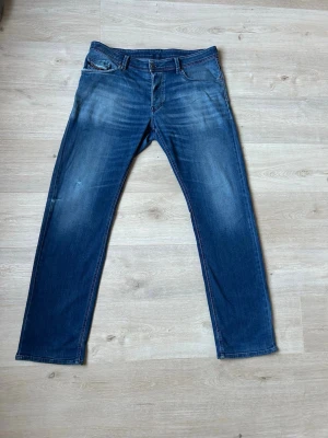Blåa Diesel Jeans Regular Fit Storlek W36 - Fina Diesel Jeans i blå färg. Jeansen är i mycket bra skick och sparsamt använda. |  Äkta som allt annat jag säljer! ✅ |  Storlek: W36 | Skick: Mycket Bra Skick - har några små slitningar (SE SISTA 2 BILDER) | Färg: Blå | Märke: Diesel | Modell: Jeans |   Hör gärna av dig vid frågor så svarar jag så fort jag kan! 😁 |  (SKU - 129)