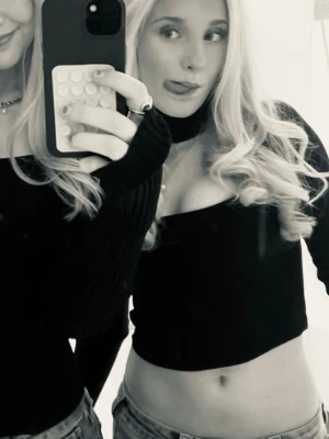 svart långärmad topp med choker - Trendig svart croppad topp med långa ärmar och fyrkantig urringning. Sitter tight och har en enkel, stilren design som passar perfekt till jeans eller kjol. Perfekt för dig som gillar en clean och modern look. Liten i storleken, slutar ungefär vid naveln. Använd fåtal gånger