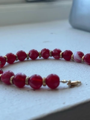 Handmade bracelet  - This is a handmade bracelet by myself, with dark red and milky white beads. It has gold beads between all beads. Beautiful bracelet to wear whenever, with an adjustable part so you can make it bigger or smaller. The beads are bought in Zanzibar and then made by me. It’s gorgeous. Check out my profile for more handmade pieces 🌸