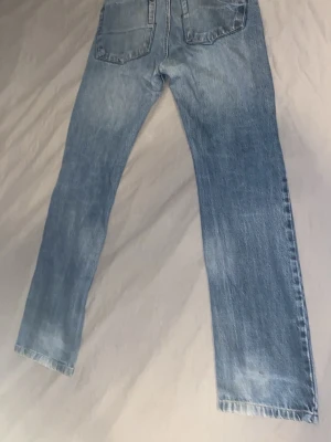 Ljusblå raka jeans från Carhartt - Ett par vintedge jeans lite utsvängda vid fötterna lite små slitna håll i ena fickan men dem är stil rena och passar till den som gillar stret wear