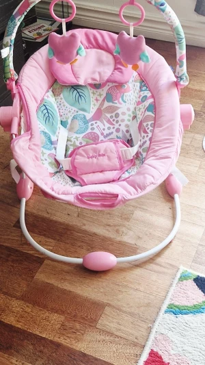 Rosa babysitter från Baby Mix - Säljer en söt rosa babysitter från Baby Mix med lekbåge och två mjuka ugglefigurer. Sitsen har färgglatt mönster med djur och blad, säkerhetsbälte och vadderad kant. Perfekt för små barn som vill leka eller vila. Om ni inte vill betala frakten(lite dyr) wå kak ni istället plocka upp den hos mig.