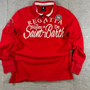 Large Spell Out Rugby Long Sleeve XXL Yacht Club College Vibe 🌊 - Gaastra “Les Voiles De Saint Barth” regatta rugby in bold marina red. Heavy cotton, contrast collar, huge front script, sleeve patches and full back graphic. Proper yacht club core / coastal prep / euro summer vibes. Size XXL (fits relaxed) 47 cm shoulder 58 cm pit to pit 76 cm length 68 cm sleeve  3 tiny dots on front (see pics) — nothing major. Overall great condition.  Perfect for: 🌊 coastal prep ⛵ yacht club aesthetic ☀️ euro summer fits 👖 baggy denim + loafers combo  Lowkey statement piece.