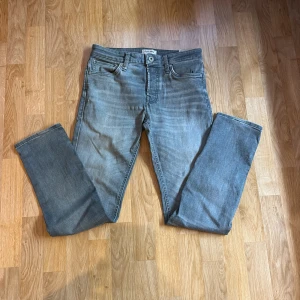 Gråa slimfit jeans - Säljer ett par gråblå slim fit jeans från Jack and Jones
