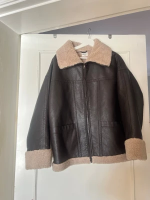 Faux jacket  - 🤎 Brown faux leather jacket with teddy lining 🤎   Selling a super stylish brown faux leather jacket with soft teddy lining and collar. Features a zip closure, cozy cuffs, and a warm inner lining — perfect for fall and winter. Trendy, comfortable, and easy to style with any outfit.    • Color: Dark brown with beige teddy lining   • Material: Faux leather   • Closure: Zipper   • Details: Teddy collar, cuffs, and hem   • Style: Trendy / cozy / winter-ready   • Condition: Very good condition    