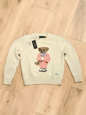 Ralph Lauren Polo Bear - Vit Polo Bear sweater med rosa bear på framsidan | Perfekt för våren | Snygg, stilren och lätt att matcha | Helt ny i perfekt skick (10/10) | Pris: 899 kr | Ställ gärna frågor!