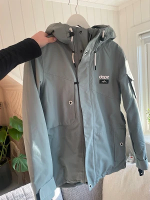 Ljusgrön Dope skidjacka  - Säljer denna fina ljusgröna skidjacka från Dope i storlek S. Den har både fickor på insidan och utsidan samt en liftkortsficka i armen. Jackan har även ventilations dragkedjor under armarna. Passar perfekt i fjällen och i alperna! Hör av er vid frågor eller fler bilder 🤍
