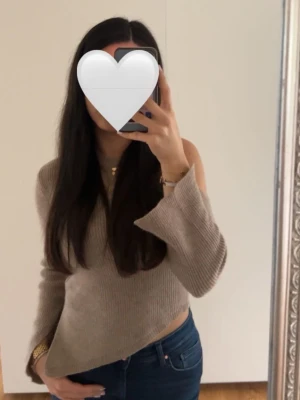 Beige stickad tröja med asymmetrisk axel - Beige stickad tröja med asymmetrisk axel, säljer då jag inte längre får användning för den. Väldigt fint skick 