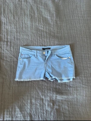 Lågmidjade jeansshorts  - Säljer ett par ljusblå  jeansshorts från Tally Weijl. Sitter jätte skönt och materialet är stretchigt!