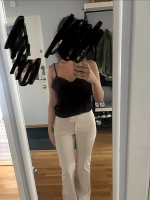 Beiga utsvängda kostymbyxor - Snygga beiga kostymbyxor med utsvängda ben och hög midja. Byxorna har en stilren och enkel design utan synliga fickor eller detaljer. Perfekta för en clean och trendig look.