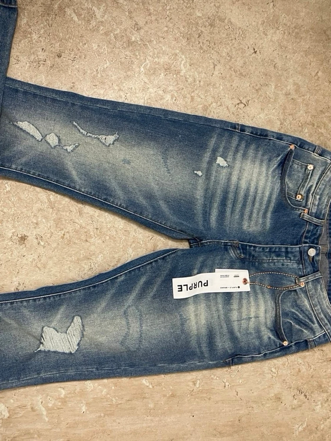 Blå slitna jeans från Purple