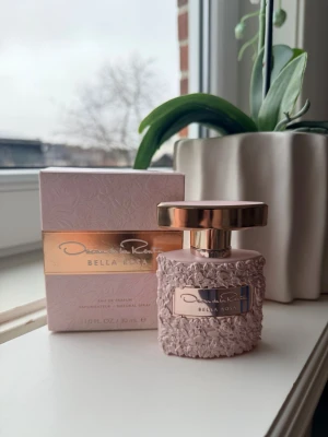 Oscar de la Renta Bella Rosa parfym - Oscar de la Renta Bella Rosa Eau de Parfum i en elegant ljusrosa flaska med rosstruktur och metallisk roséguld-kork. Parfymen kommer i en matchande ljusrosa kartong med rosrelief och gulddekor. Volymen är 30 ml.