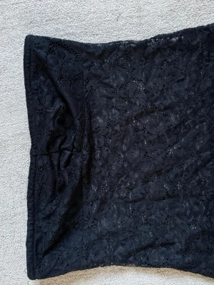 Black lace tube top Y2K XS-S - Black lace tube top Y2K XS-S  Description: Super cute black lace tube top with a floral lace pattern 🖤 Stretchy and comfortable fit that looks flattering on. Perfect for parties, going out, layering, or everyday outfits. Easy to style with jeans, skirts, or low rise pants ✨  Good condition.  Size: XS-S (stretchy fit) Color: Black  