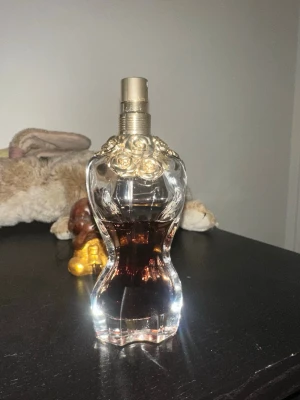 Jean Paul Gaultier La Belle EdP 50ml - Jean Paul Gaultier La Belle Eau de Parfum i en unik, kurvig glasflaska med guldiga rosdetaljer vid halsen. Flaskan rymmer 50 ml, mycket mer än hälften kvar. Köptes för 1300kr.  