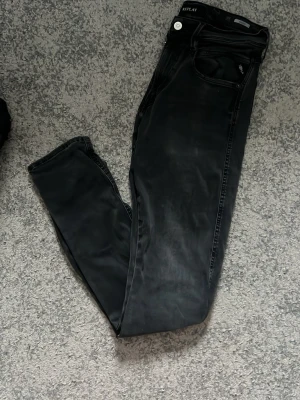Replat ”anbass” (svarta) 31/32 - Snygga svarta jeans från Replay. Replay-logga på bakfickan. Tillverkade i mjukt denimtyg som ger en bekväm känsla och stilren look. Strlk: W31 L32