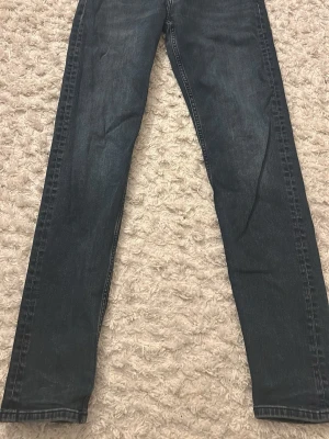 Mörkblå raka jeans från J.Lindeberg - Snygga mörkblå jeans från J.Lindeberg med raka ben och klassisk femficksmodell. Jeansen har dragkedjegylf och diskret JL-logga på myntfickan. Tillverkade i mjukt denimtyg som ger en bekväm känsla och stilren look. 