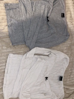 Två ribbade tröjor från Gina Tricot i storlek XS. båda två för 100kr! - Säljer två långärmade ribbade tröjor från Gina Tricot, en i ljusgrått och en i vitt. Båda har smala ränder och en liten svart rosett framtill vid urringningen. Perfekta att matcha med jeans eller kjol. Storlek XS i båda, 100kr får båda två💕💕
