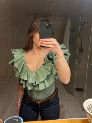 Zara Body med volanger - Helt ny super snygg body från Zara med volanger som tyvärr inte passade mig. Den är helt ny och oanvänd med lappen kvar. Säljs inte längre säljer pågrund av att den aldrig kommit till användning då den är lite liten på mig Storlek S