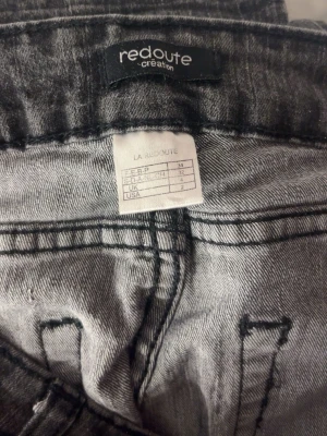Grå tvättade jeans från Redoute - Snygga grå tvättade jeans från Redoute Creation med klassisk femficksmodell och raka ben. Jeansen har tydliga sömmar och en cool, lite sliten look som passar perfekt till en avslappnad stil. Materialet är mjukt denim som ger en bekväm känsla hela dagen. Säljer pga att dom är för korta.