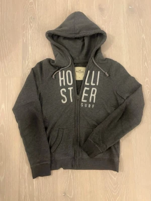 Hollister - Tjena säljer en snygg grå hollister hoddie med dragkedja framtill. Säljer den för 399kr. Skriv vid minsta fundering eller fråga, svarar så fort som möjligt. Den är storlek M (passar S/xs)