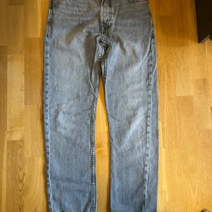 Grå jeans från Jack & Jones - Snygga grå jeans från Jack & Jones med klassisk design. De har en rak passform och är tillverkade av kvalitativt bomullstyg. Perfekta för en avslappnad stil.