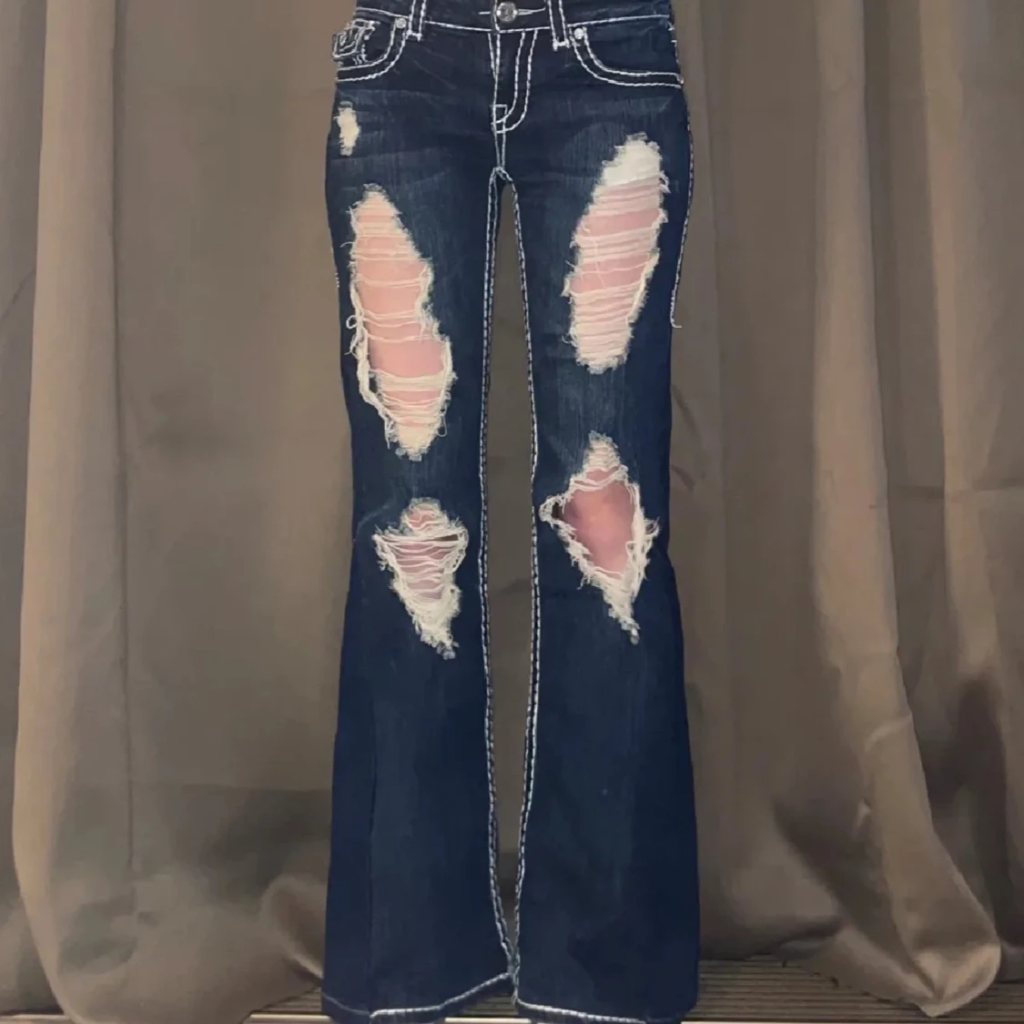 Mörkblå bootcut jeans med slitningar