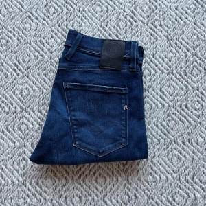 Replay Anbass jeans  - Säljer ett par snygga mörkblå Replay jeans i modellen anbass. Jeansen är i nyskick och har inte ett enda tecken på användning. Storleken på jeansen är W29/L32. Vid minsta fråga eller fundering är det bara att höra av sig👍😁