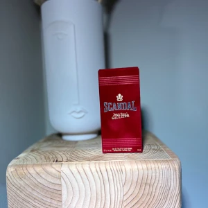 Jpg Scandal EDT 50ml - Elegant parfymflaska från Jean Paul Gaultier med namnet Scandal. Flaskan är genomskinlig med en lyxig guldfärgad kork formad som en krona. Förpackningen är djup röd med tydlig text. Perfekt för den som vill ha en doft med attityd och stil. Luktar söt och karamell, perfekt för året runt men mer på kyligare dagarna. Ca 12% använd, kommer med originella förpackningen. Nypris runt 800-900.
