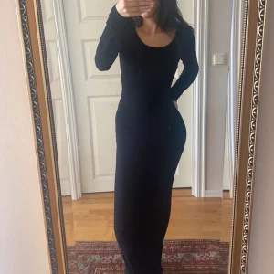 Svart klänning  - Lång svart klänning i bra skick. Förutom ett litet litet hål på ena armen. Men inget man lägger märke till.