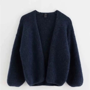 Mörkblå kofta från Zara - Mysig mörkblå kofta från Zara i ett fluffigt material. Perfekt för kyliga höst- och vinterdagar. Den har en öppen design utan knappar och långa ärmar. Superfin att slänga över en t-shirt eller blus för en avslappnad look.