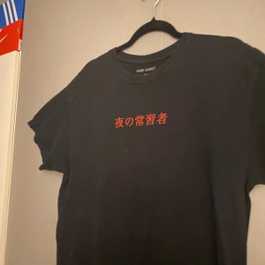 Black streetwear t-shirt graphic size L barley used and good quality - Black graphic T-shirt size L good quality barley used size M-Lwith red text Japanese nightaddict #tshirt #streetwear #y2k #grapictee #graphictshirt #graphic #y2kstyle #nightaddict